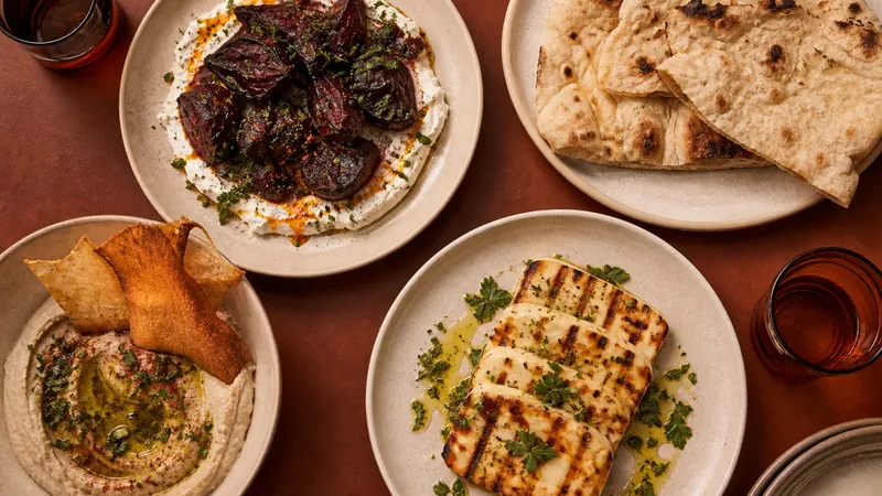 Selection of starters including beetroot, flatbread, halloumi, and aubergine dip